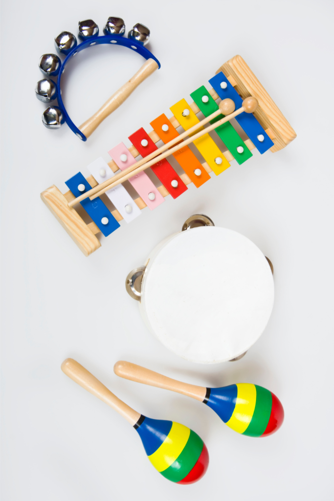 Classroom percussion instruments including maracas, tambourines, rhythm sticks, triangles, and claves used in elementary music lessons.